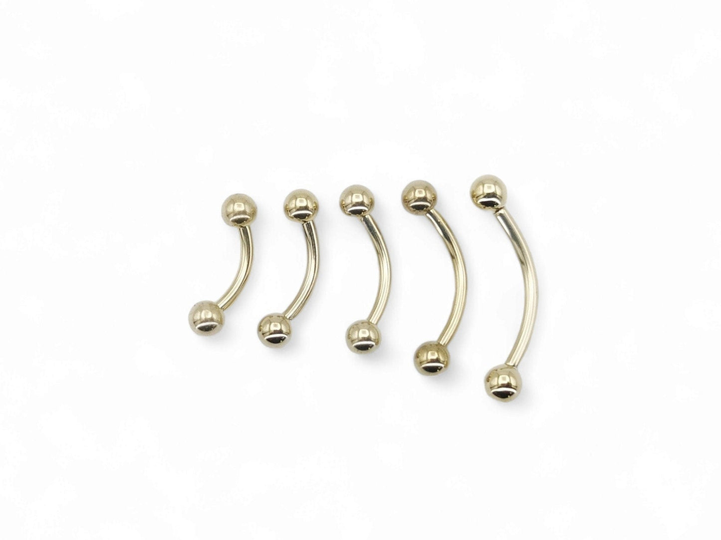 A black or gold titanium curved barbell, externally threaded for piercings, with a screw-fit ball.