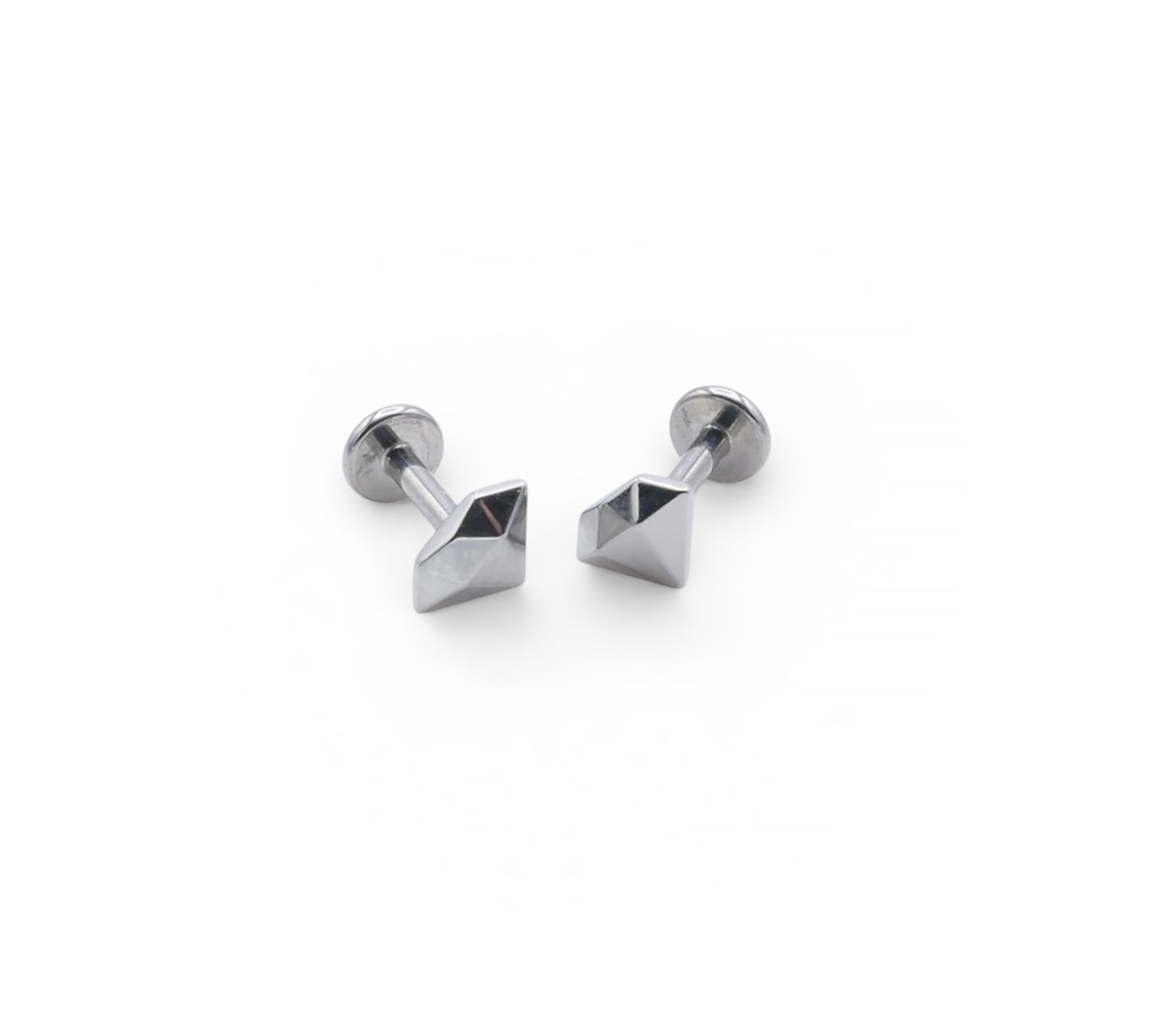 Pair of silver stud earrings with pyramid-shaped tops on a white background