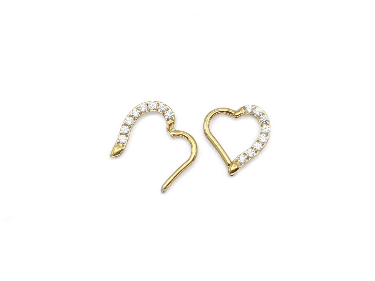 A pair of gold titanium jewelled heart clickers with PVD gold finish, designed for daith piercings.
