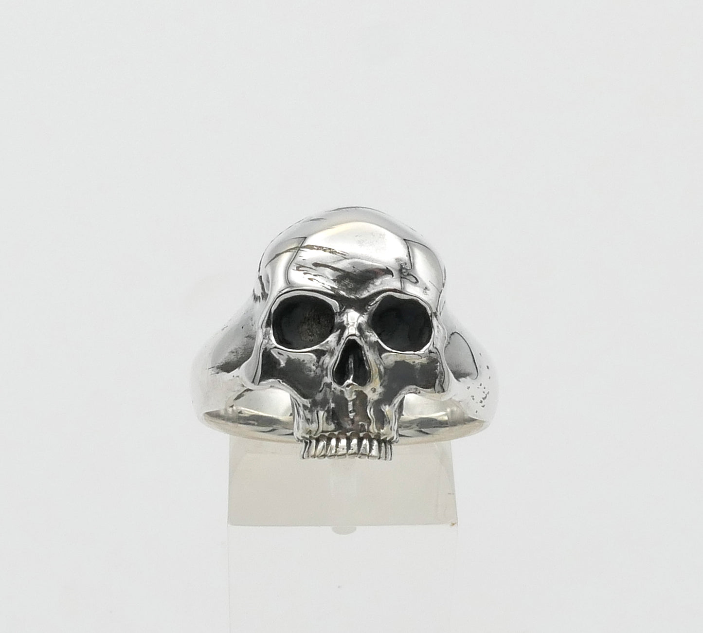 Silver skull ring on a white background