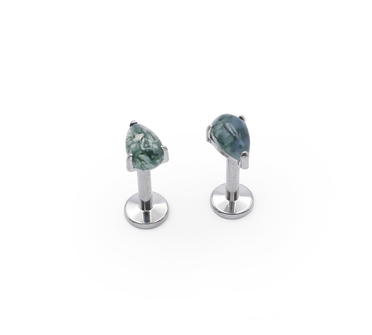 Pair of silver teardrop earrings with green gemstones on a white background