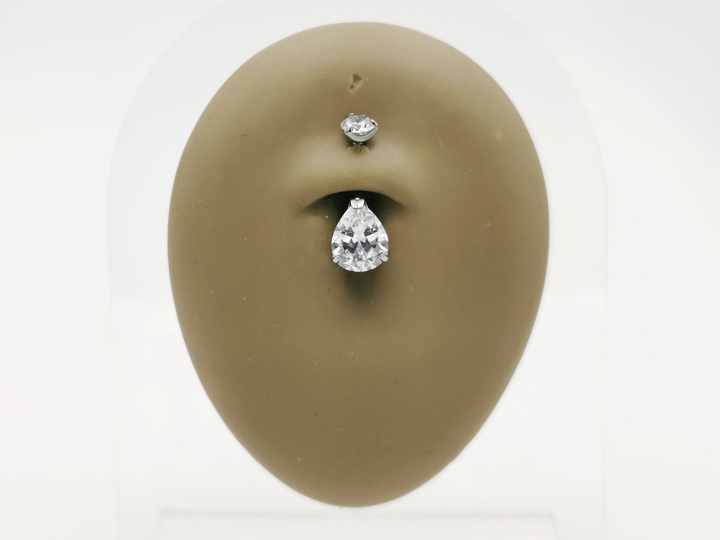Titanium jewelled claw set belly bar on a mannequin