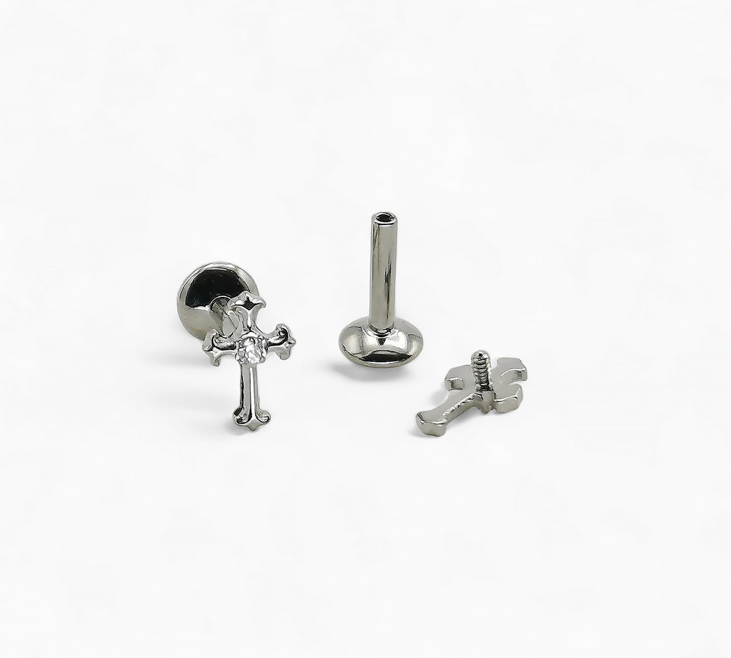 Set of silver cross-shaped earrings on a white background