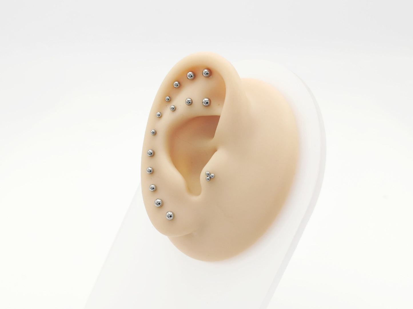 A collection of polished titanium push-fit mini ball studs in various lengths displayed against a white background.