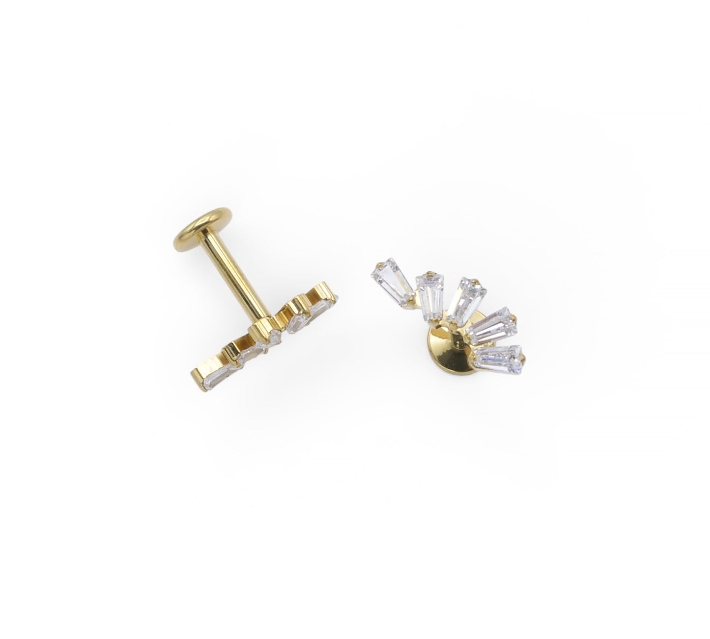Gold earring with clear gemstones on a white background
