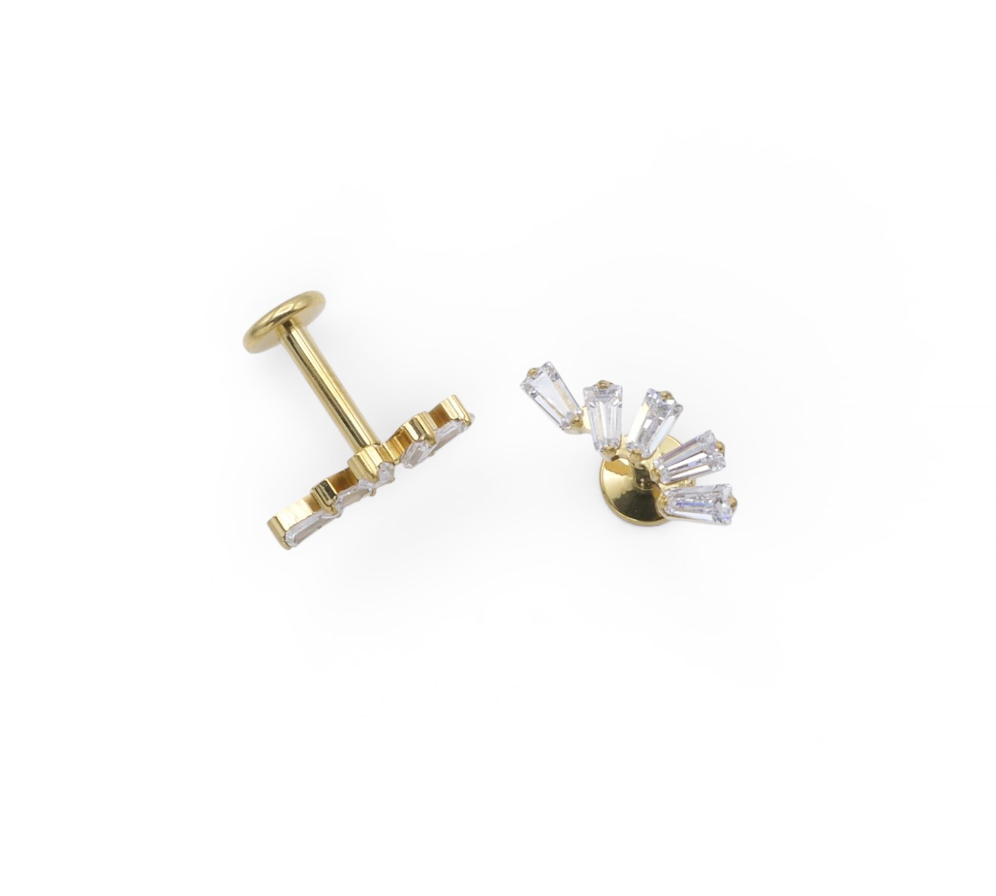Gold earring with clear gemstones on a white background