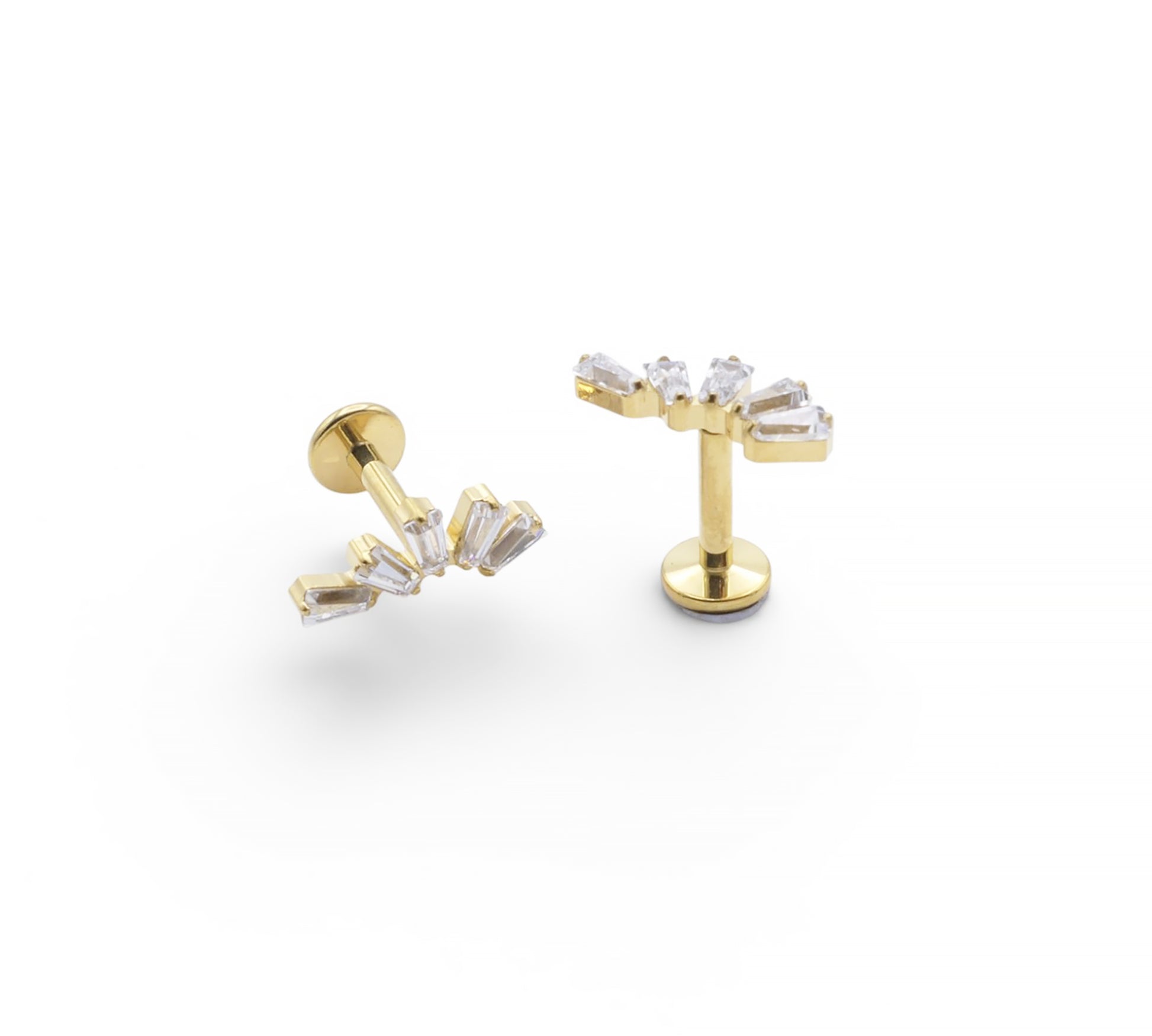 Gold earrings with clear gemstones on a white background