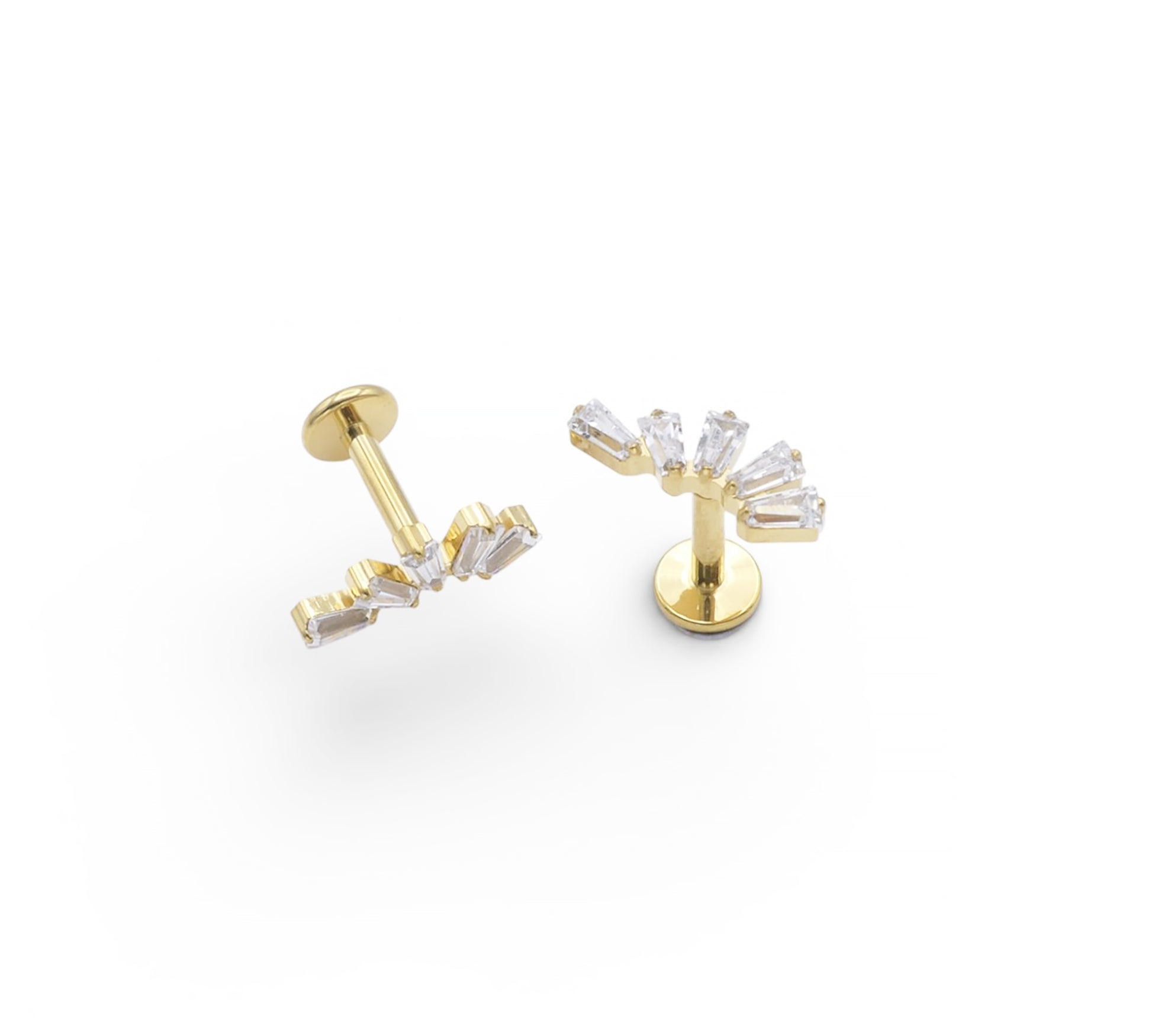 Gold earrings with clear gemstones on a white background