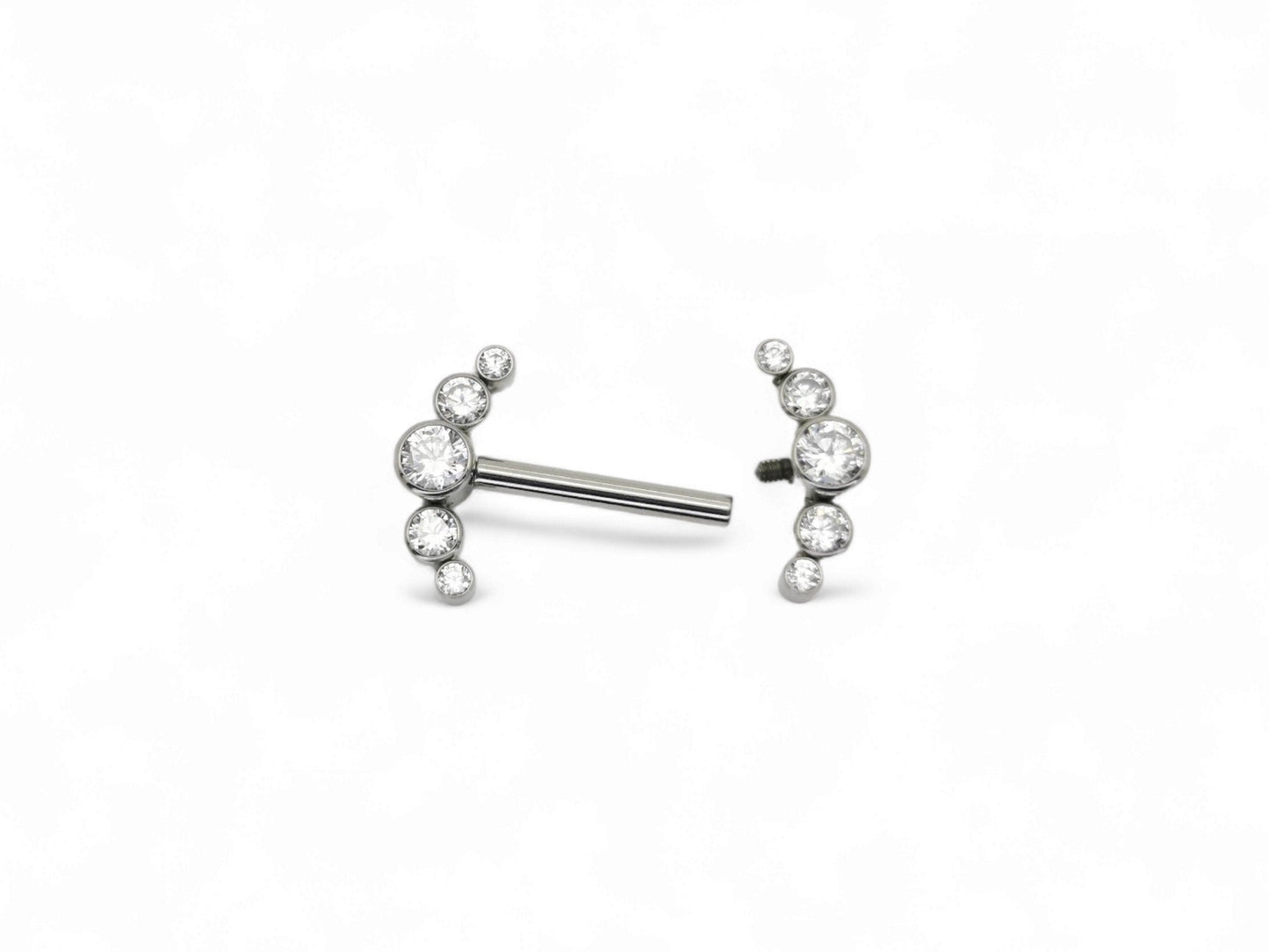 A titanium barbell piercing with a jewelled crescent design featuring five brilliant cut crystal gemstones.