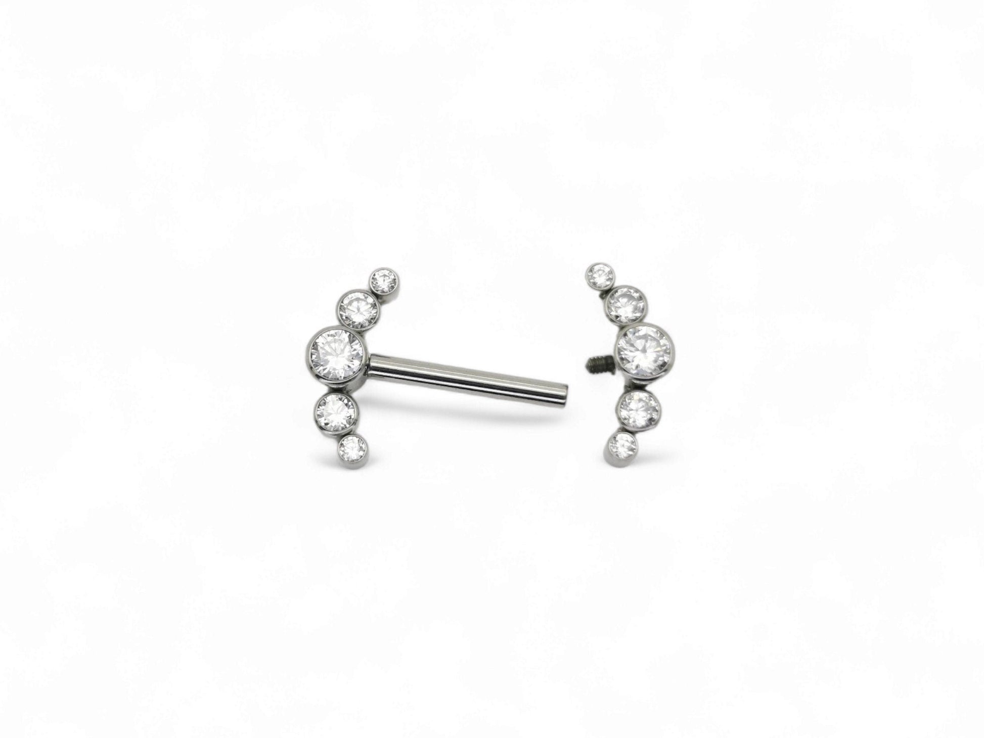 A titanium barbell piercing with a jewelled crescent design featuring five brilliant cut crystal gemstones.