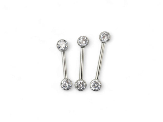 A set of three jewelled titanium barbells with clear faceted crystals, arranged in a row on a white background.