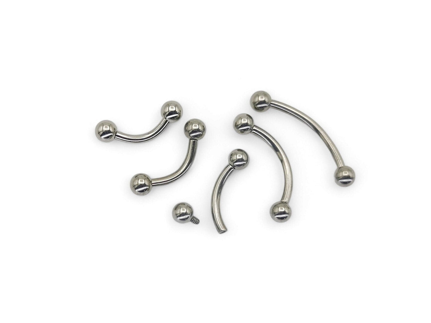 A collection of titanium curved barbells with screw fit balls, varying in length, on a white background.