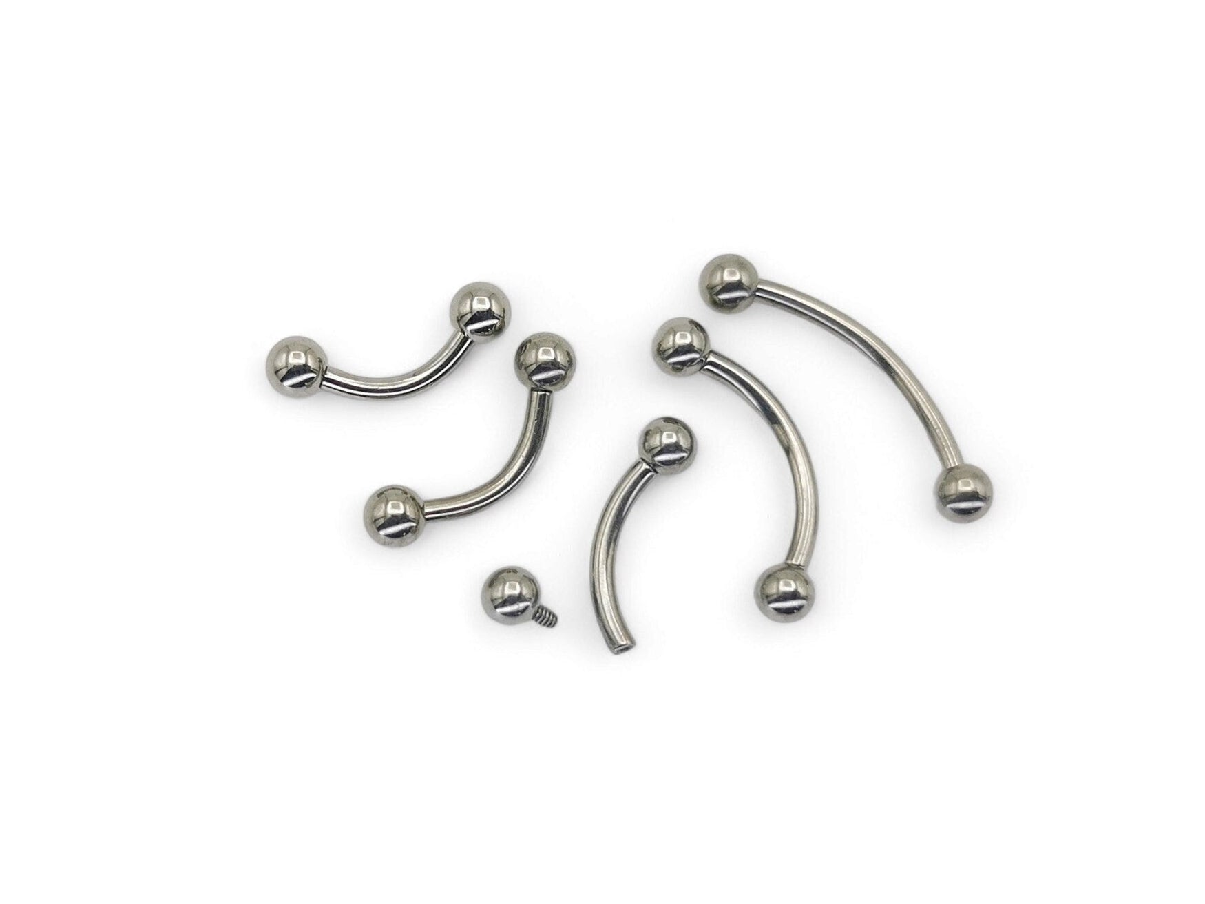 A collection of titanium curved barbells with screw fit balls, varying in length, on a white background.