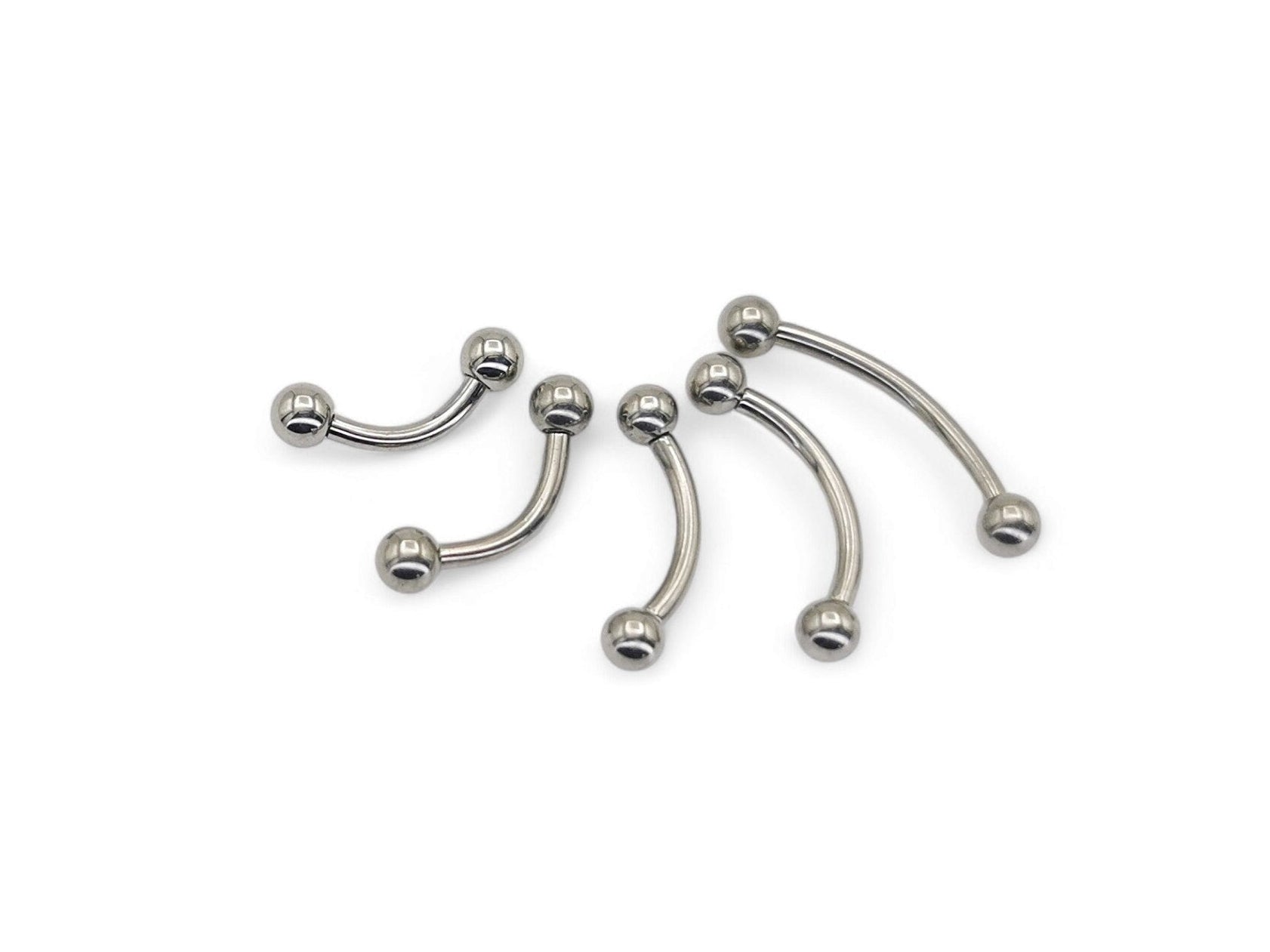 A collection of titanium curved barbells with screw fit balls, varying in length, on a white background.