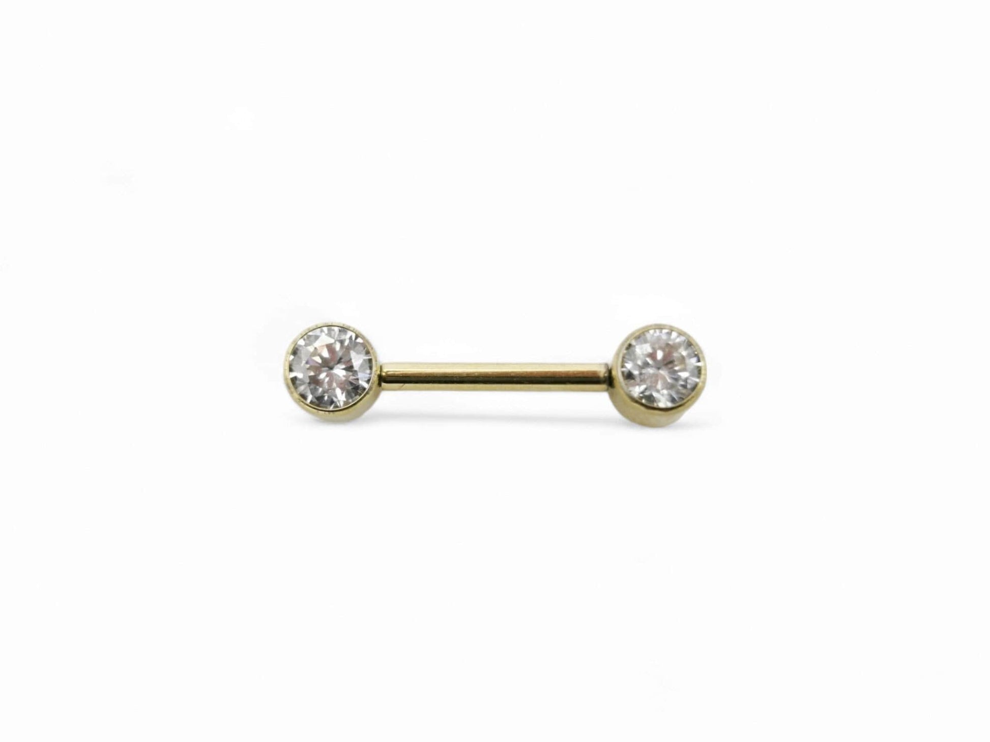 A gold-colored titanium barbell with a clear faceted crystal on the bezel, intended for nipple piercings.