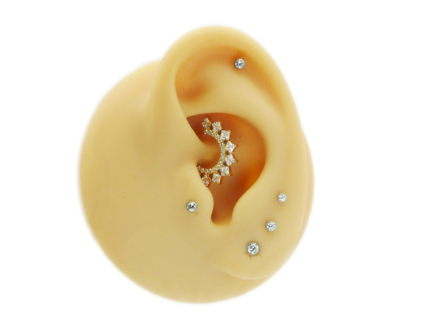 A gold titanium hinged clicker ring with a cluster of square-cut clear gems around the central ring for septum or daith piercings.