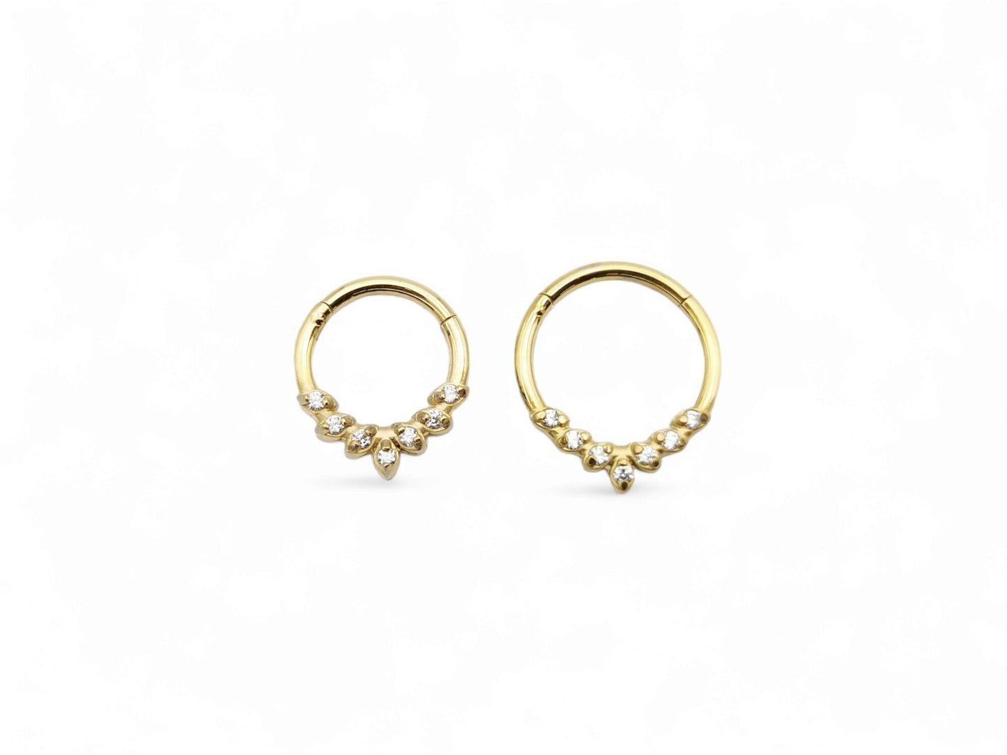 Gold surgical steel jewelled laurel clicker ring with cubic zirconias on a white background