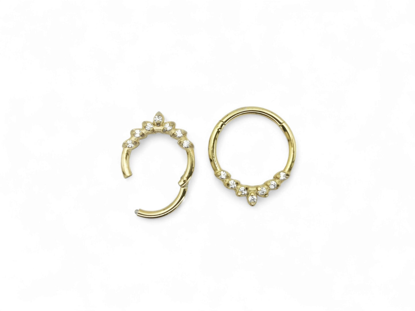 Gold surgical steel jewelled laurel clicker ring with cubic zirconias on a white background