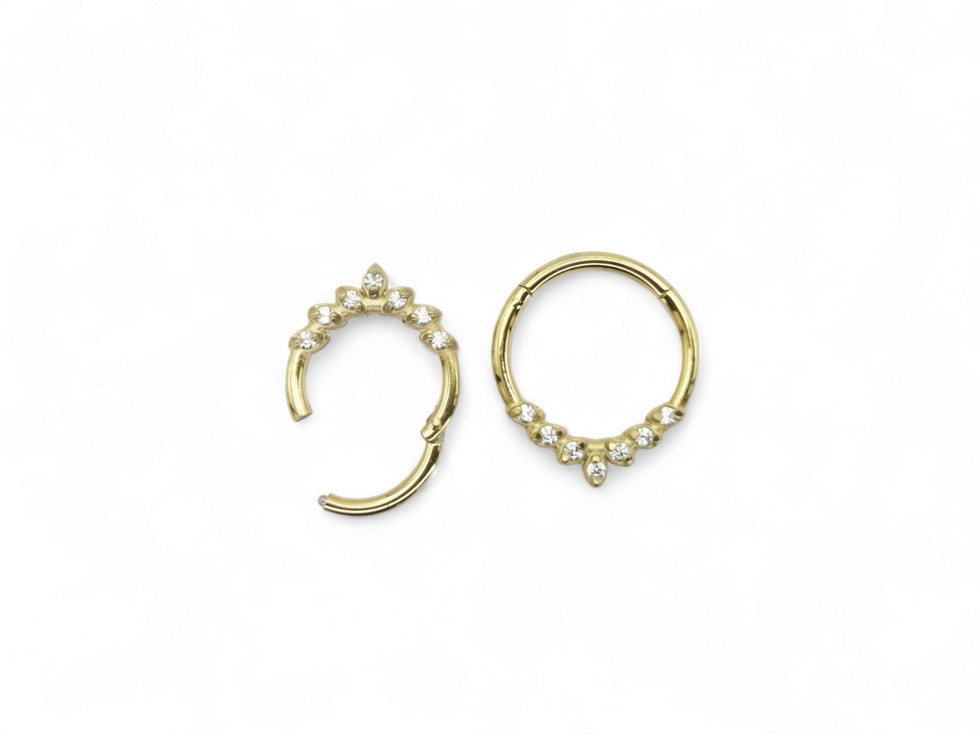 Gold surgical steel jewelled laurel clicker ring with cubic zirconias on a white background