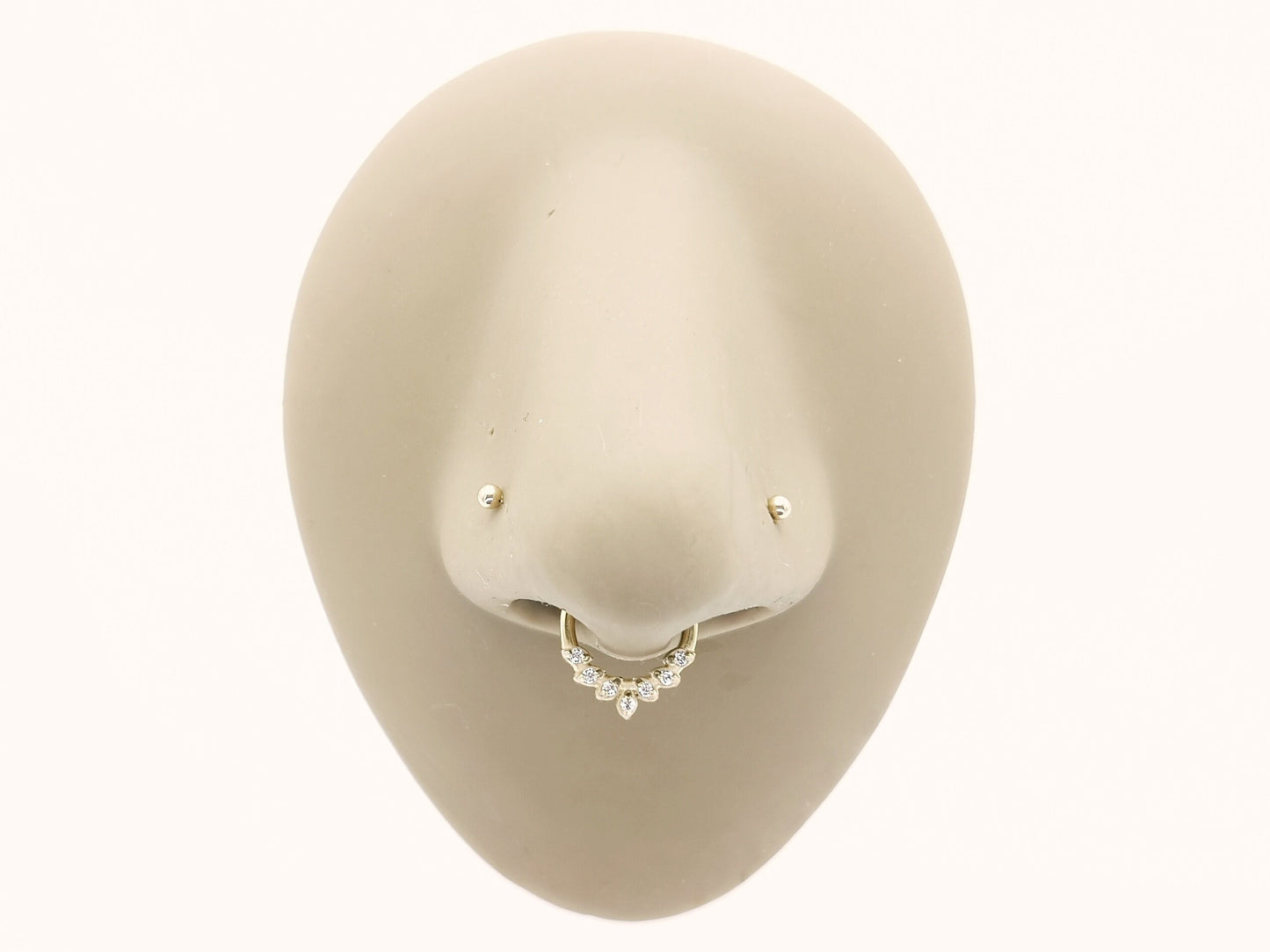 Gold surgical steel jewelled laurel clicker ring on a mannequins nose