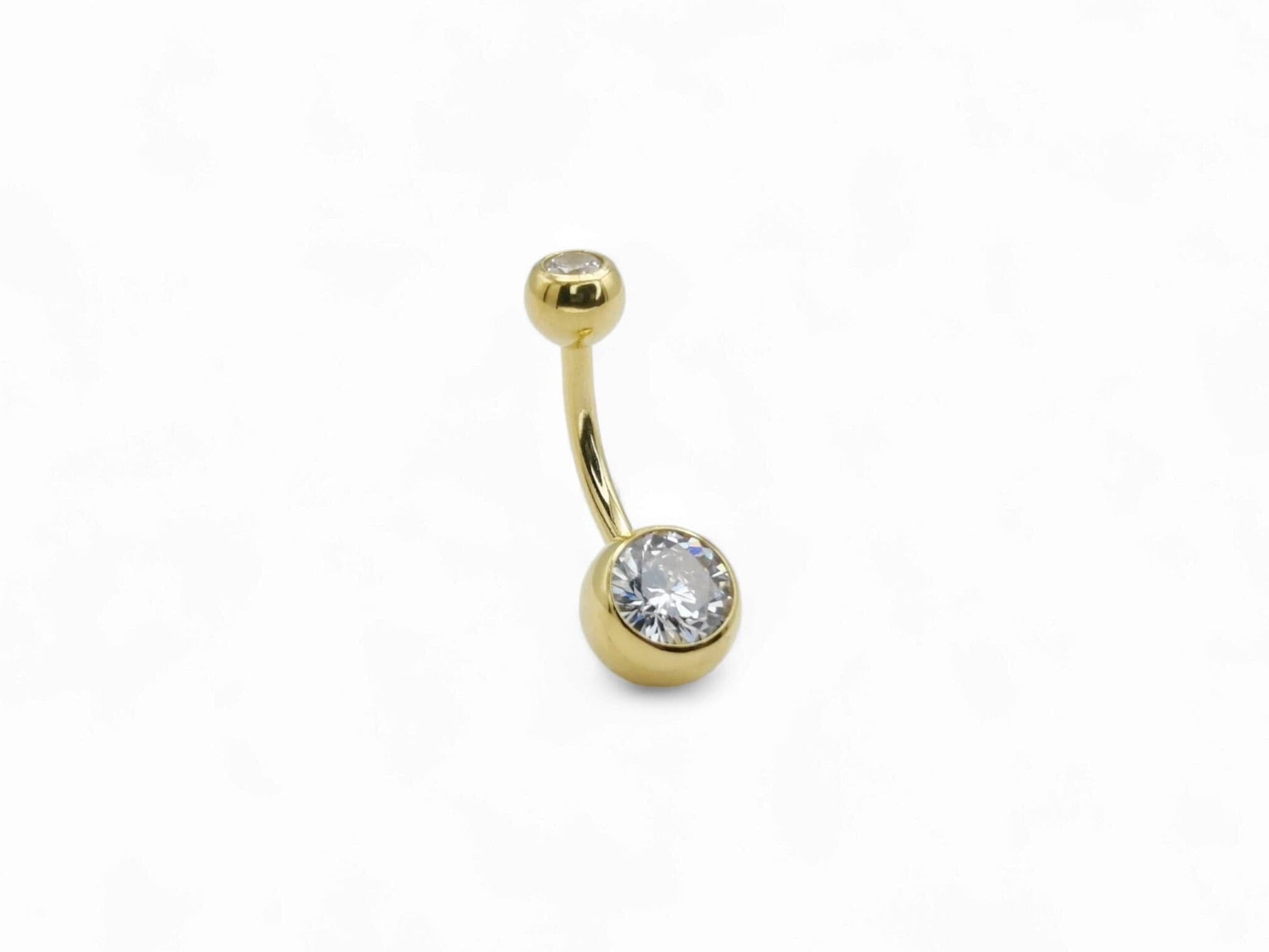 Gold titanium double jewelled navel bar with a white cubic zirconia on a clear background.