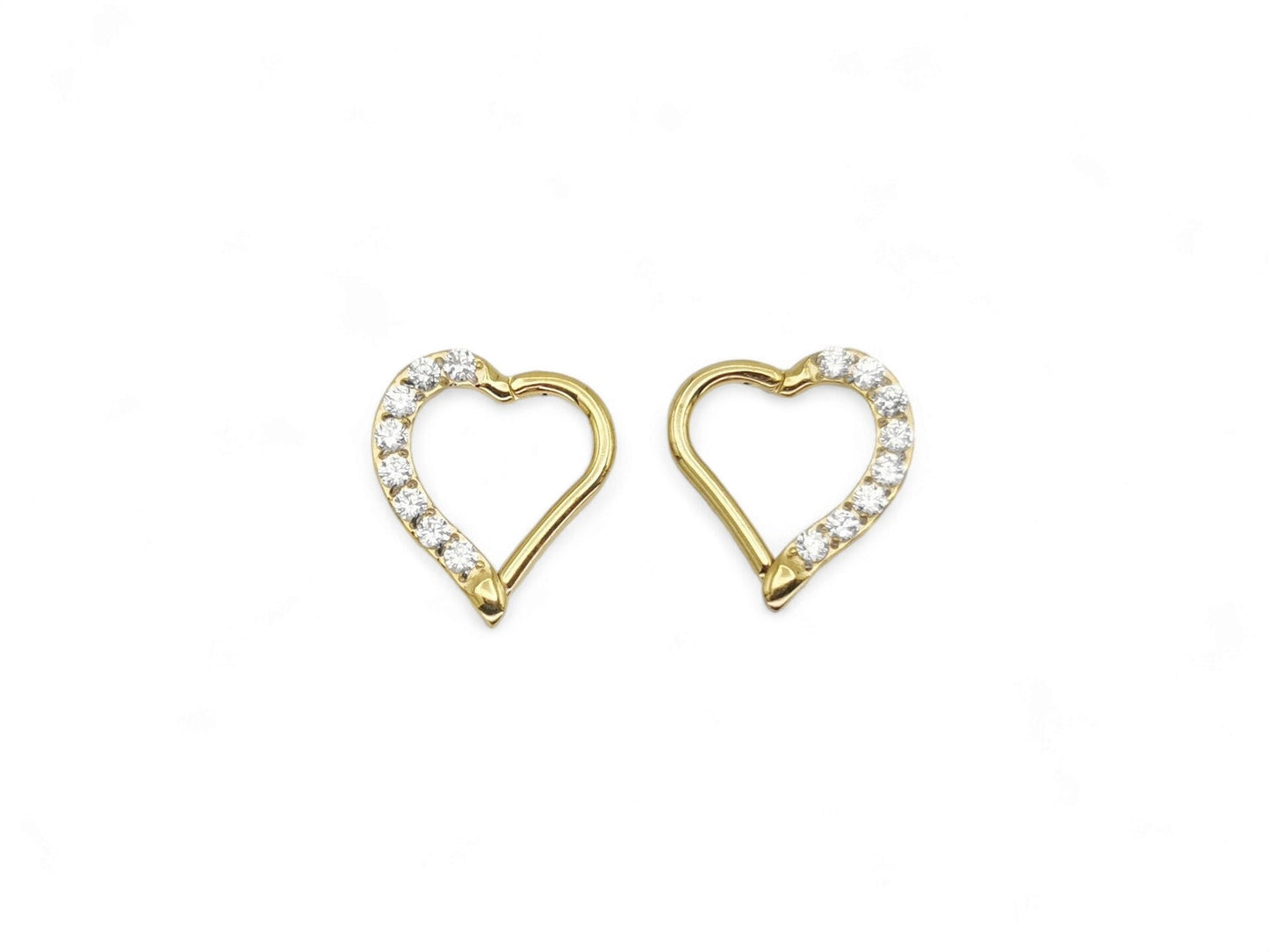 A pair of gold titanium jewelled heart clickers with PVD gold finish, designed for daith piercings.