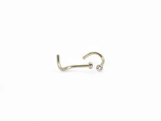 Gold titanium jewelled nose stud on a white background