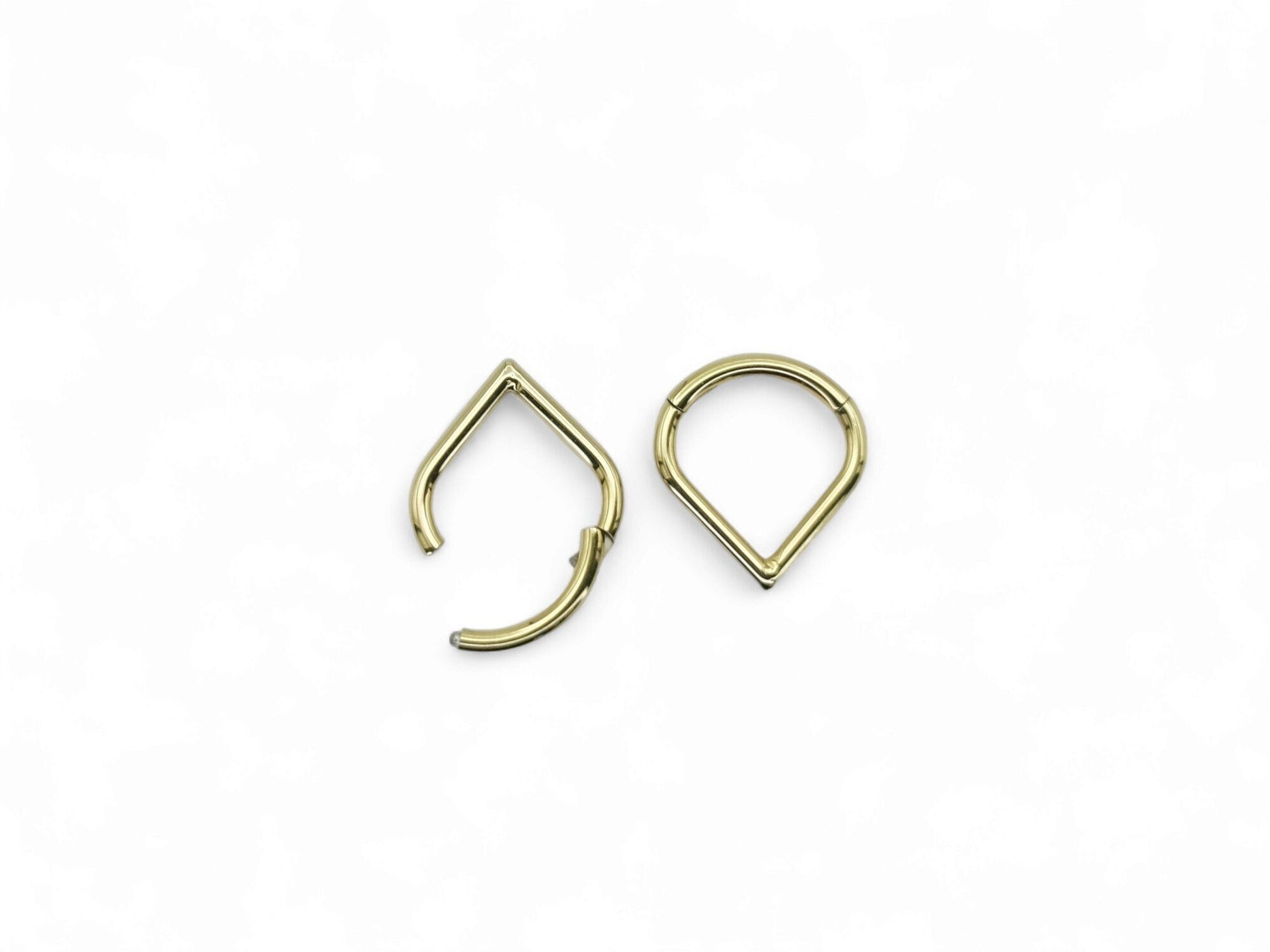 Gold titanium wishbone clicker on a white background