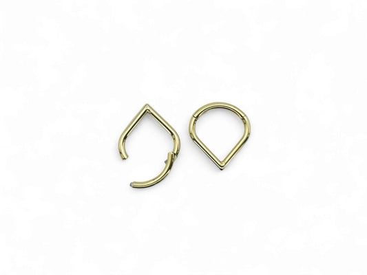 Gold titanium wishbone clicker on a white background