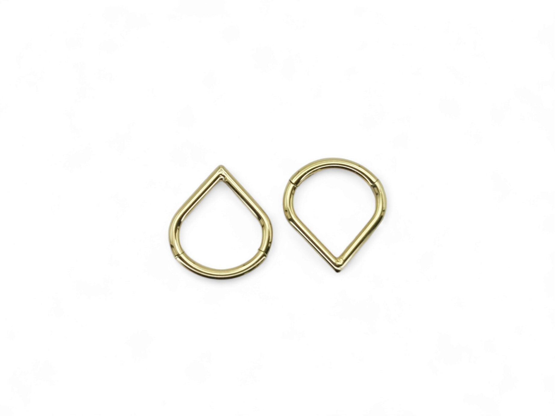Gold titanium wishbone clicker on a white background