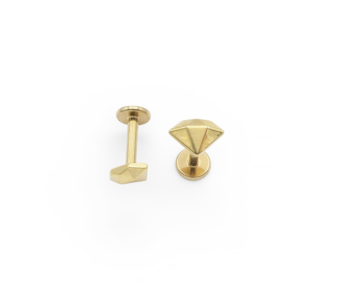 Two gold-colored earring studs on a white background