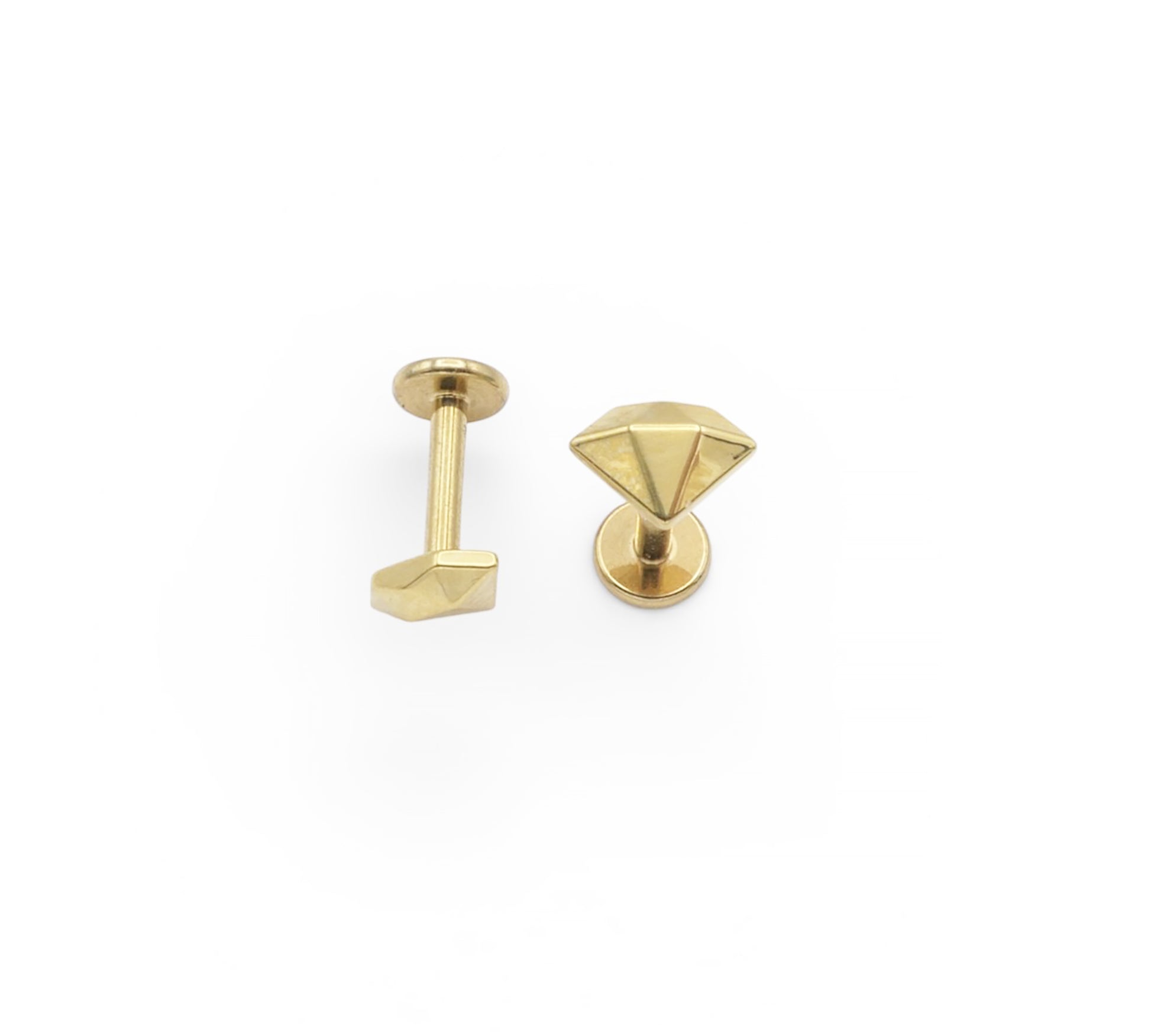 Two gold-colored earring studs on a white background