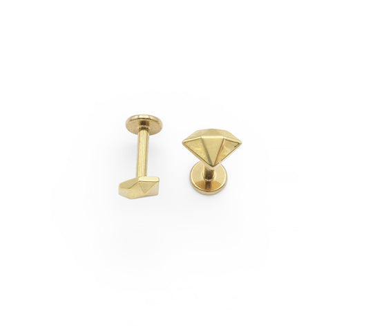 Two gold-colored earring studs on a white background