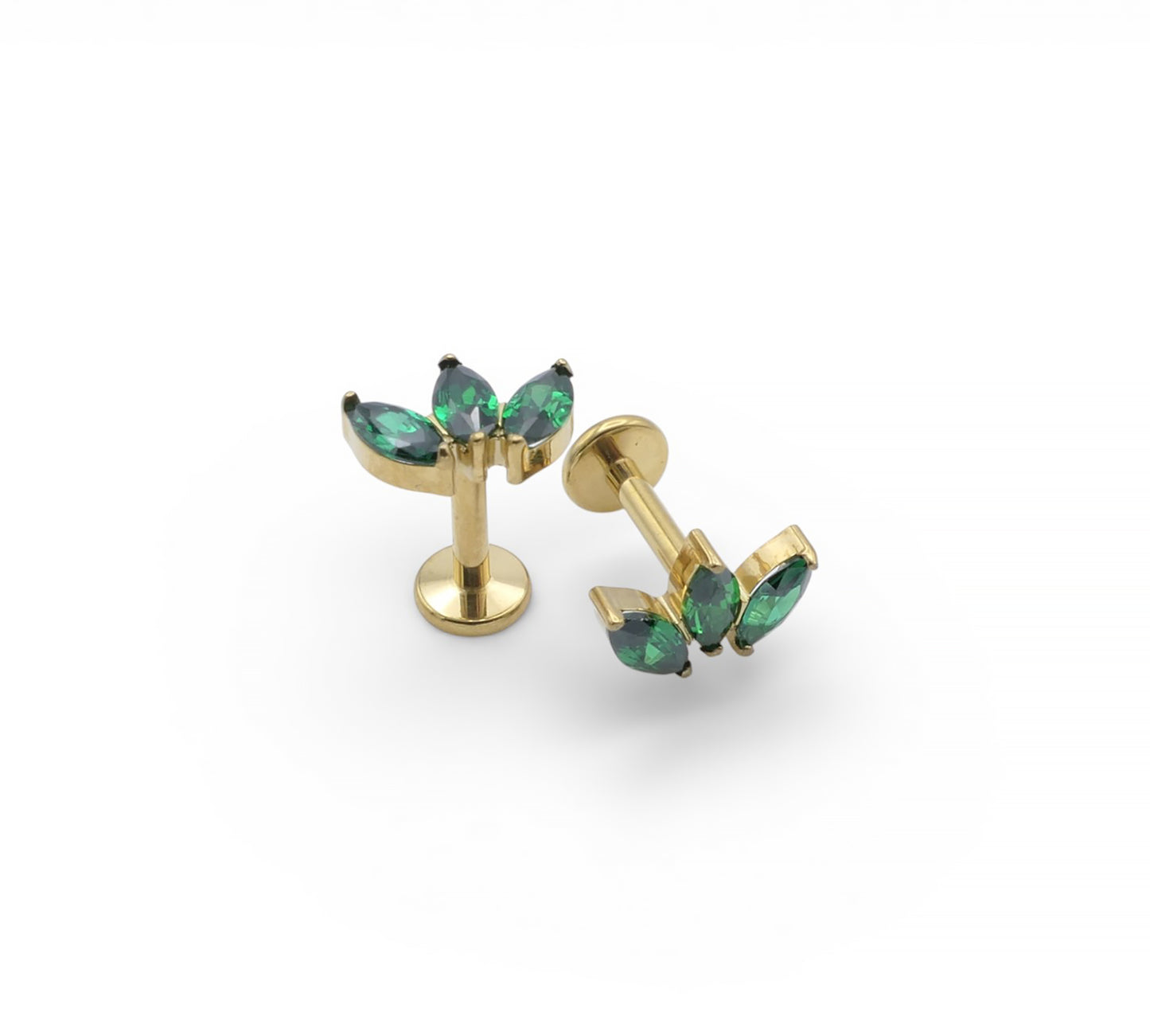 Gold earrings with green gemstones on a white background
