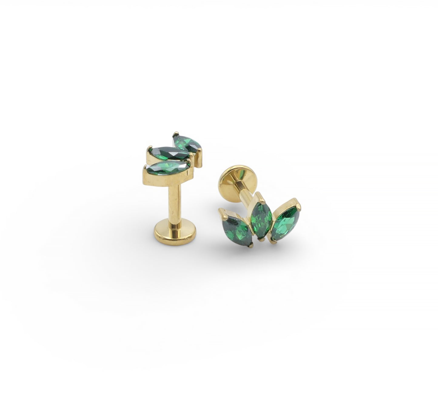 Gold earrings with green gemstones on a white background