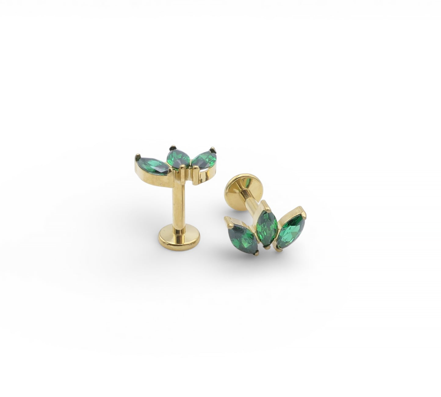 Gold earrings with green gemstones on a white background