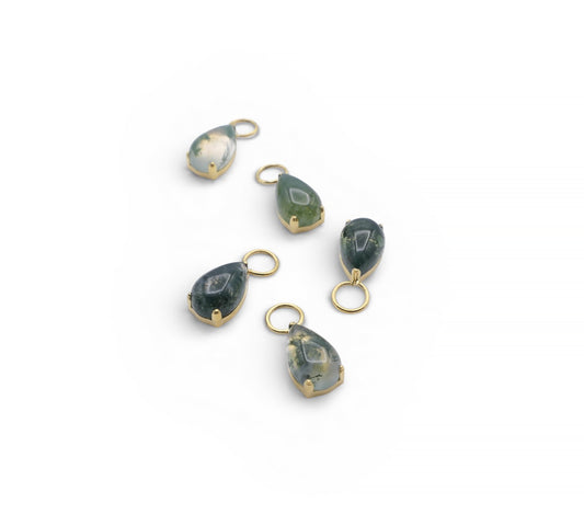 Set of green teardrop pendants with gold loops on a white background