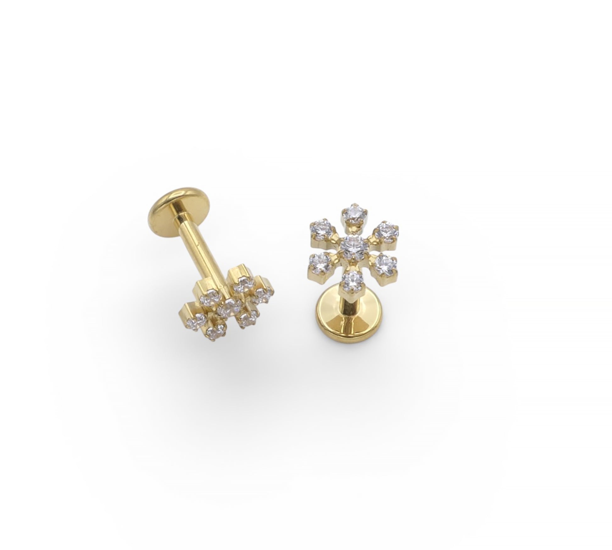 Gold earrings with diamond-like stones on a white background