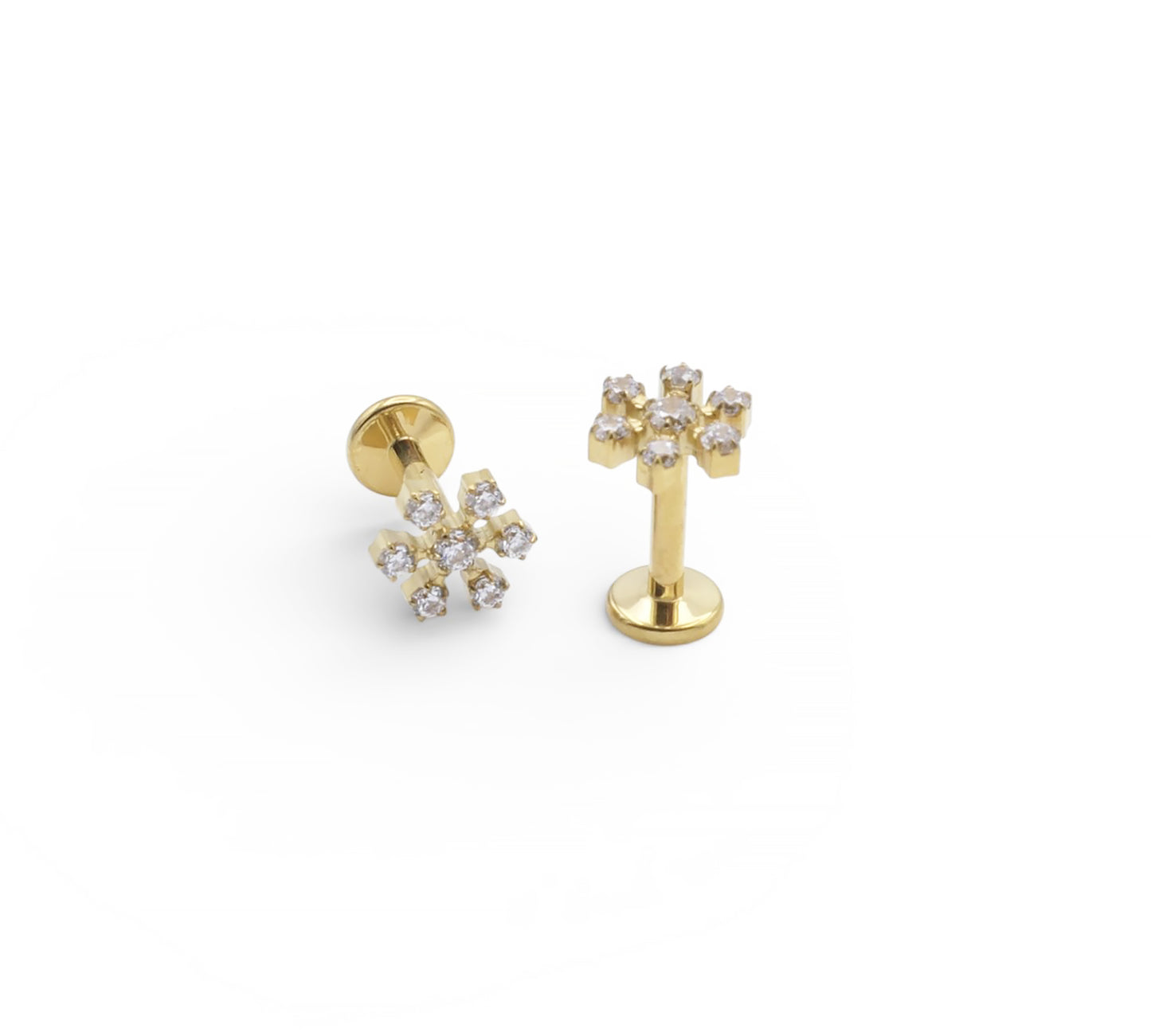 Gold earrings with diamond-like stones on a white background