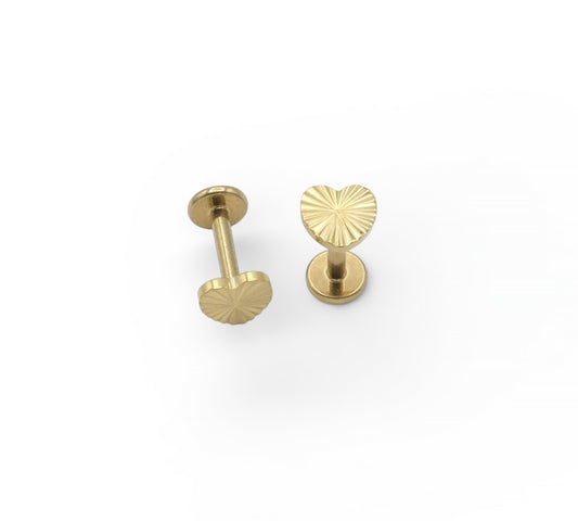 Two gold earrings on a white background