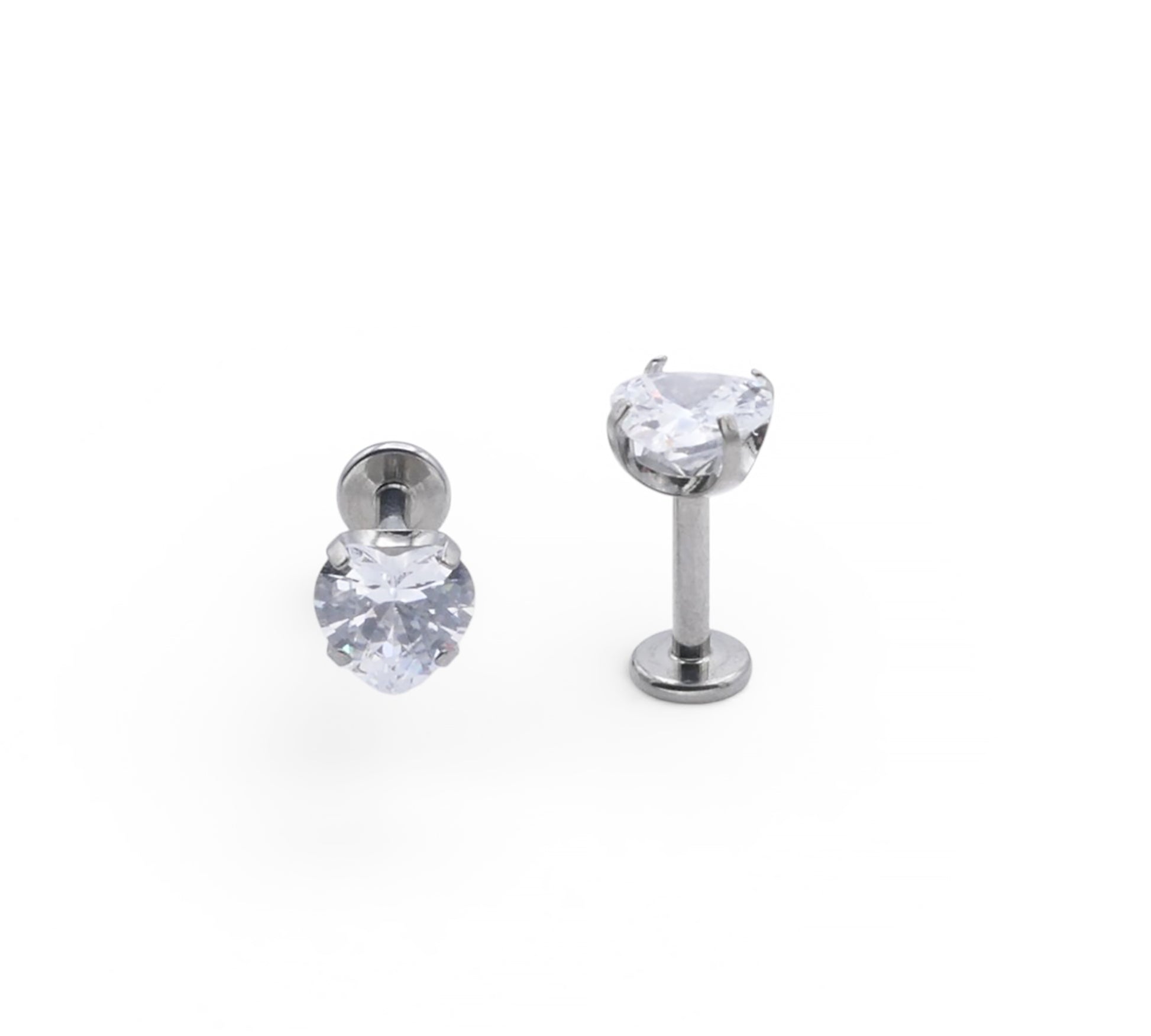 Heart shape crystal ear studs on a white background