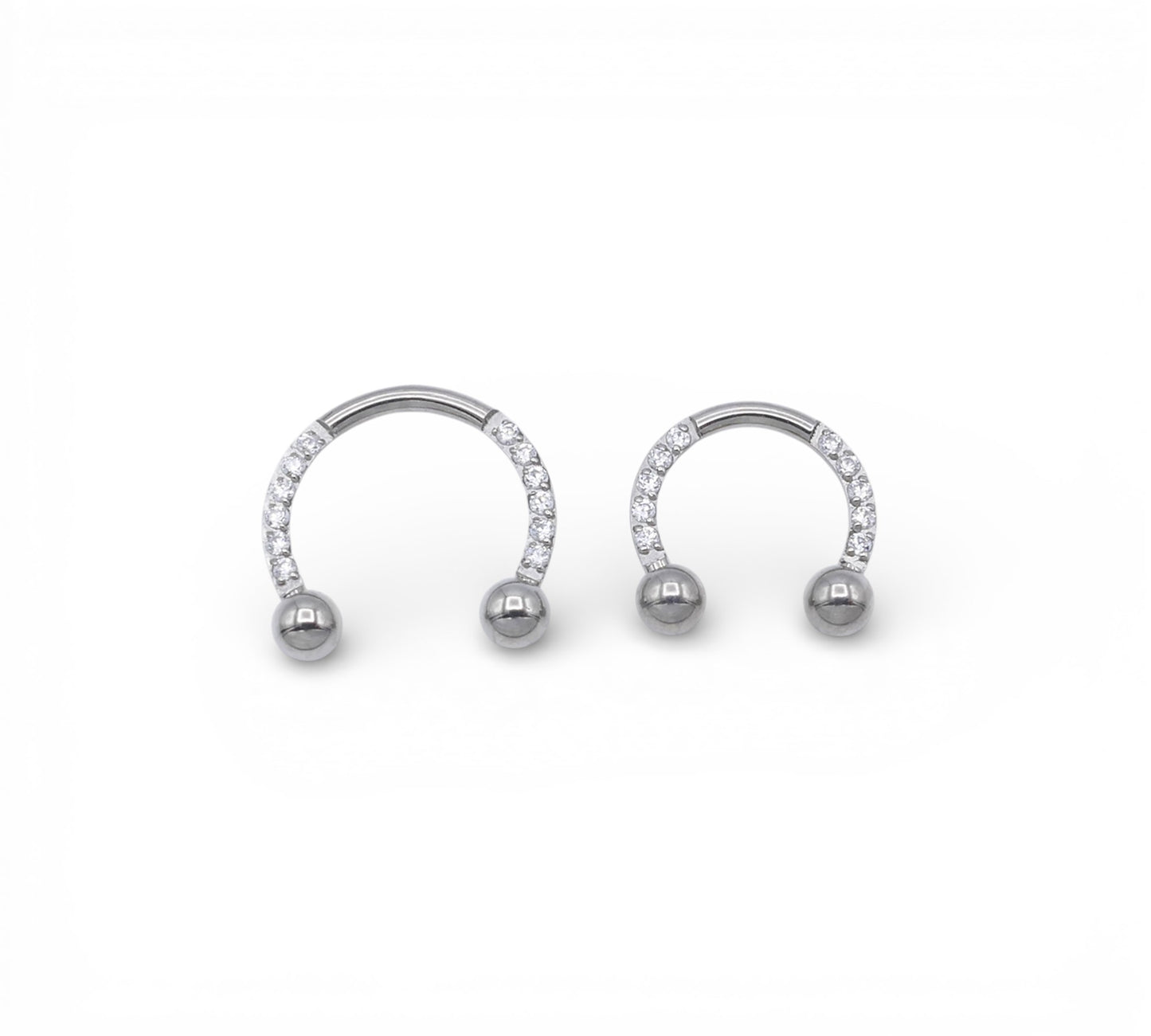 Jewelled circular barbells on a white background