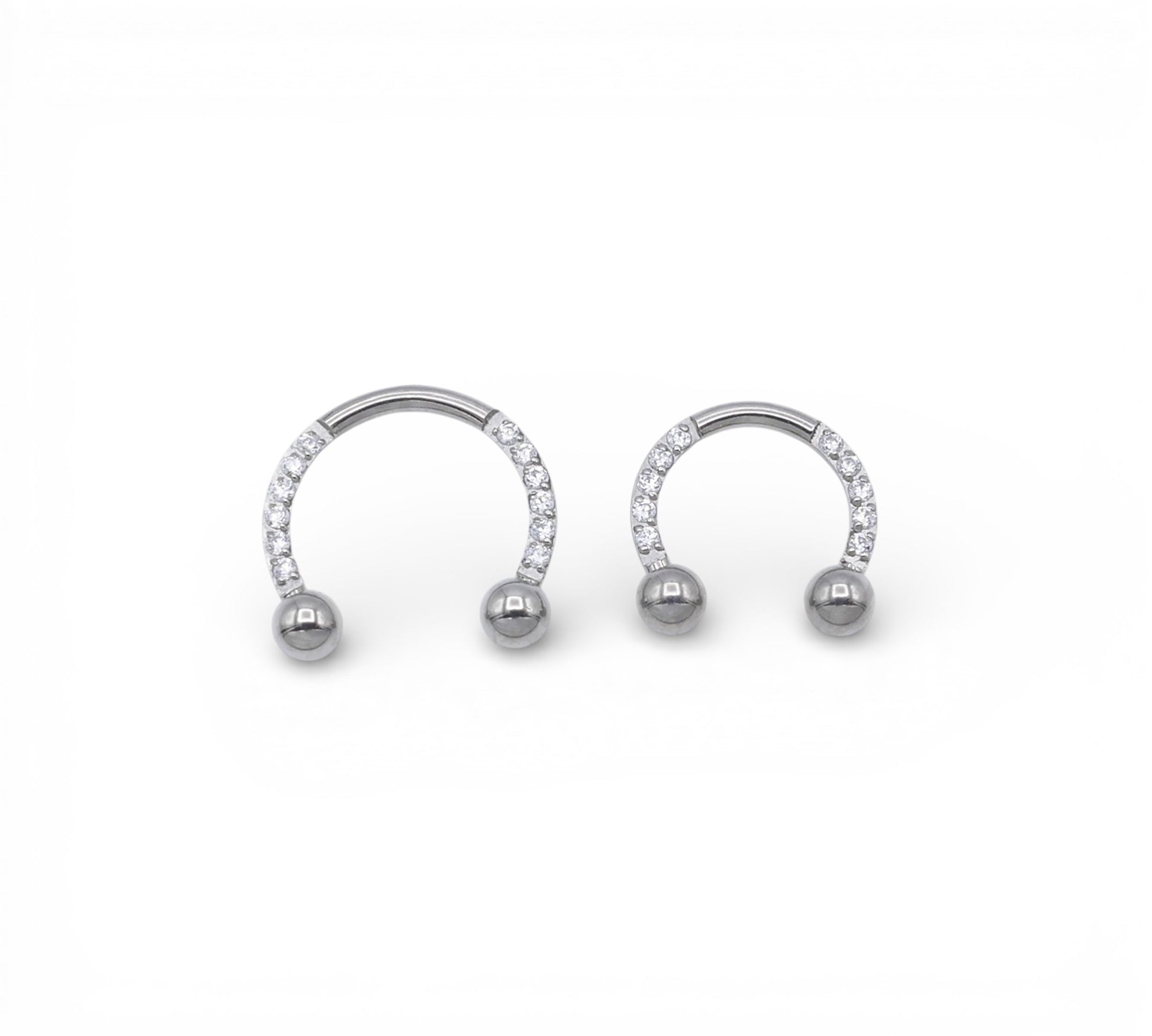 Jewelled circular barbells on a white background