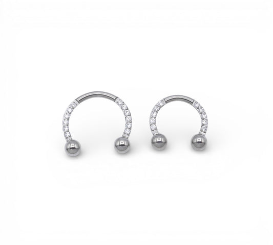 Jewelled circular barbells on a white background