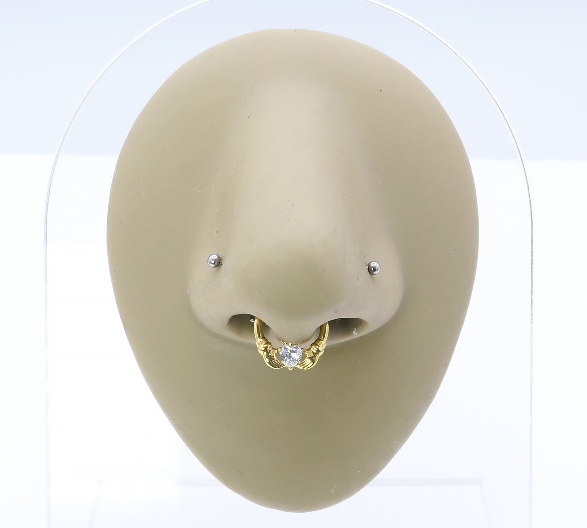 Jewelled Gold Titanium Claddagh Clicker ring on a nose model