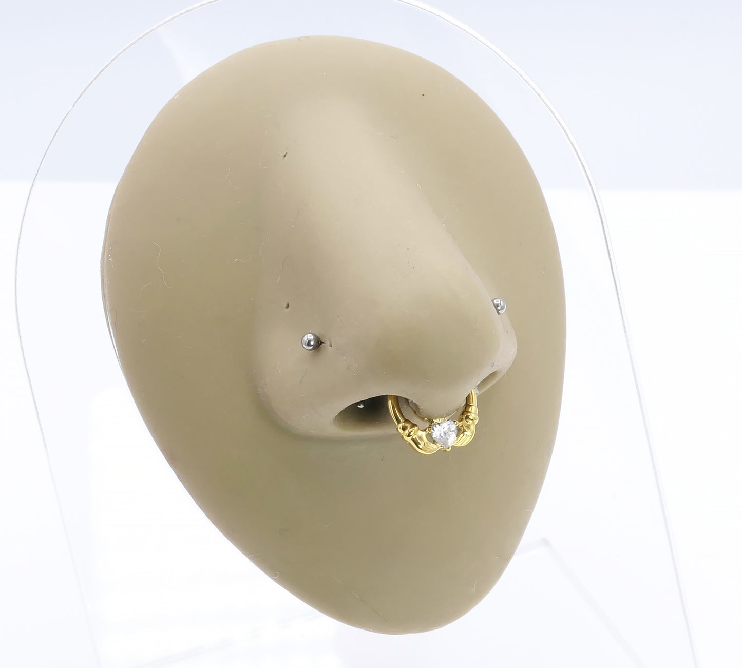 Jewelled Gold Titanium Claddagh Clicker ring on a nose model