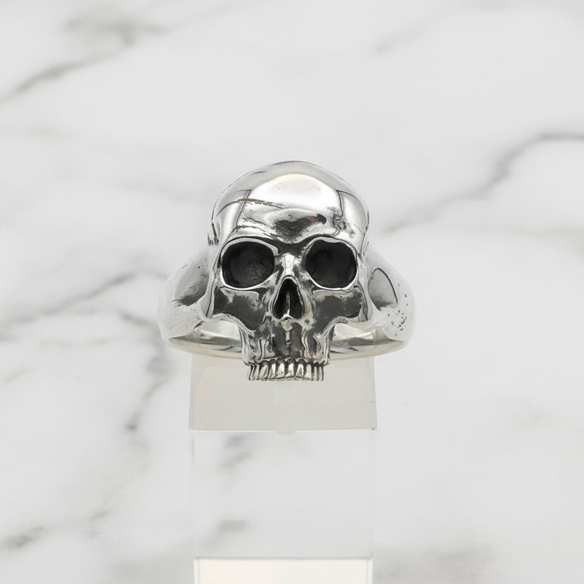 Silver skull ring on a white background