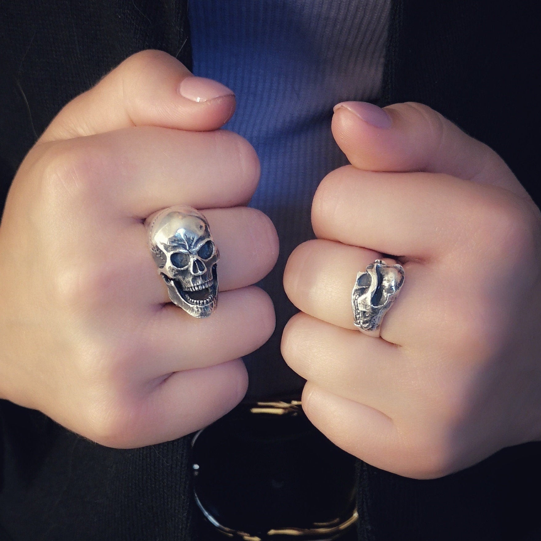skull rings on human hands