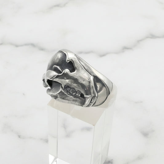 Silver bear skull ring on a white background