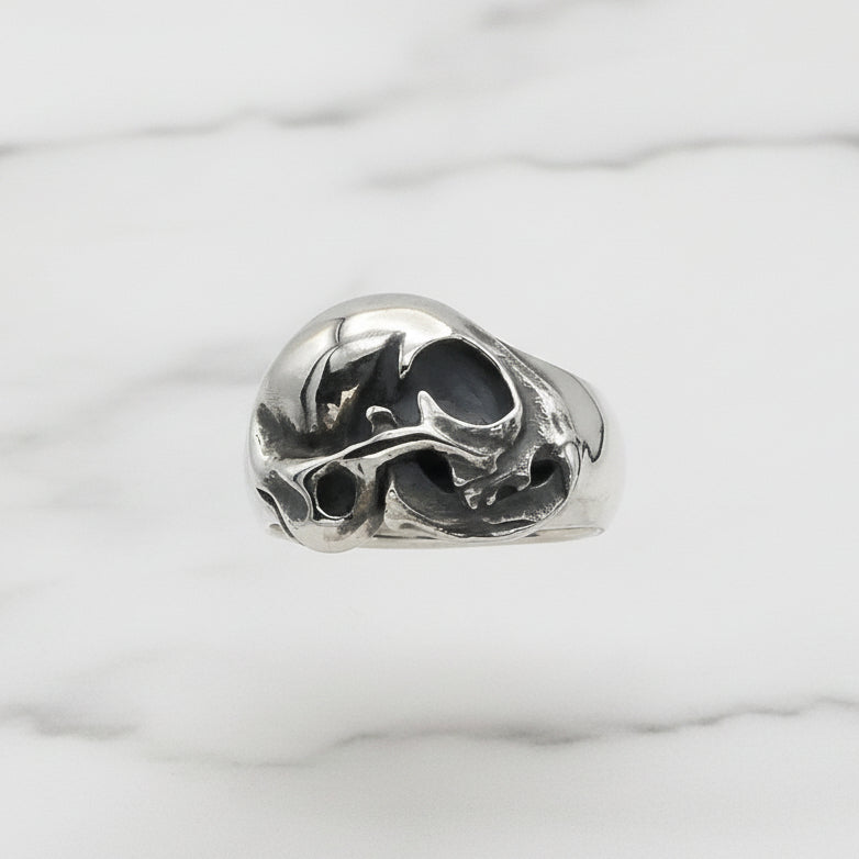 Silver cat skull ring on a white background